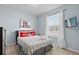 Bright bedroom with a comfortable bed, mounted TV, and ample natural light from the window at 926 Paradise Dr, Davenport, FL 33897