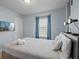 Comfortable bedroom features a queen bed, TV, and neutral colors at 926 Paradise Dr, Davenport, FL 33897