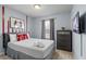 Charming bedroom with a queen-size bed, colorful accents, and a mounted TV at 926 Paradise Dr, Davenport, FL 33897