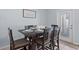 Dining room with a table for six, tile floors, neutral walls, and a glass panel front door at 926 Paradise Dr, Davenport, FL 33897