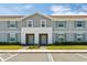 Charming two-story townhomes with gray siding and blue shutters offering a welcoming curb appeal at 926 Paradise Dr, Davenport, FL 33897