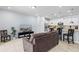 Living room with tile floors, open to kitchen, neutral walls, and a television for relaxing entertainment at 926 Paradise Dr, Davenport, FL 33897