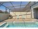 Inviting screened-in pool with lounge chairs and grill, perfect for outdoor relaxation and enjoyment at 926 Paradise Dr, Davenport, FL 33897