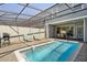 Screened-in pool with lounge chairs and outdoor dining area for relaxation and entertainment at 926 Paradise Dr, Davenport, FL 33897