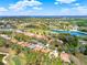 Aerial shot showcasing the neighborhood with ponds, trees, and golf course at 9346 San Jose Blvd, Howey In The Hills, FL 34737