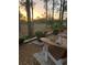Serene backyard view with seating area, flower pots, and views of the golf course at 9346 San Jose Blvd, Howey In The Hills, FL 34737