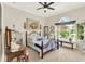 Comfortable bedroom with iron bed frame, large window, decorative accents, and ample natural light at 9346 San Jose Blvd, Howey In The Hills, FL 34737