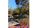 Charming street view surrounded by lush trees and colorful flowers at 9346 San Jose Blvd, Howey In The Hills, FL 34737