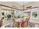 Bright dining room featuring wood table, chandelier, and sliding glass doors leading to an outdoor patio at 9346 San Jose Blvd, Howey In The Hills, FL 34737