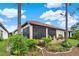 Exterior view of a home with a screened lanai and manicured landscaping at 9346 San Jose Blvd, Howey In The Hills, FL 34737