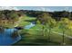 Picturesque golf course with a winding stream, bridge, and lush green fairways and trees on a sunny day at 9346 San Jose Blvd, Howey In The Hills, FL 34737