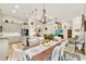 Open concept kitchen and dining area with modern appliances, kitchen island, and stylish decor at 9346 San Jose Blvd, Howey In The Hills, FL 34737
