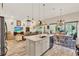Open-concept kitchen with an island, modern appliances, and seamless flow to dining and living areas at 9346 San Jose Blvd, Howey In The Hills, FL 34737