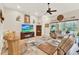 Inviting living room with comfortable seating, ceiling fan, fireplace, and a view of the outdoors at 9346 San Jose Blvd, Howey In The Hills, FL 34737