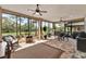 Spacious screened patio with tile flooring, ceiling fans, and golf course views at 9346 San Jose Blvd, Howey In The Hills, FL 34737
