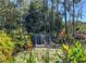Water feature with lush vegetation and a tranquil waterfall at 9346 San Jose Blvd, Howey In The Hills, FL 34737
