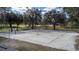 Sandy volleyball court surrounded by trees, perfect for outdoor recreation and community events at 9346 San Jose Blvd, Howey In The Hills, FL 34737