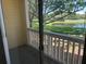 Enjoy the peaceful lake view from the private outdoor balcony with white railings and lush green scenery at 1013 S Hiawassee Rd # 3626, Orlando, FL 32835