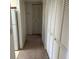 Hallway featuring multiple closets and leading to kitchen at 1013 S Hiawassee Rd # 3626, Orlando, FL 32835