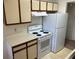 A kitchen with white appliances and light wood cabinetry at 1013 S Hiawassee Rd # 3626, Orlando, FL 32835