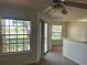 Bright living room features large windows with lake views and access to the outdoor balcony at 1013 S Hiawassee Rd # 3626, Orlando, FL 32835