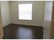 A well-lit bedroom with wood-look flooring and a large window at 1083 S Hiawassee Rd # 635, Orlando, FL 32835