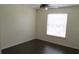 Bedroom with wood-look flooring, ceiling fan, and plenty of natural light at 1083 S Hiawassee Rd # 635, Orlando, FL 32835