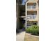 Exterior view of the three-story condo building with access stairwells and lush landscaping at 1083 S Hiawassee Rd # 635, Orlando, FL 32835