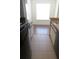 Galley kitchen with tile floor transitioning to hardwood and window over the sink at 1083 S Hiawassee Rd # 635, Orlando, FL 32835