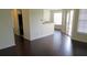 Open-concept living room with dark wood flooring and access to a private patio at 1083 S Hiawassee Rd # 635, Orlando, FL 32835