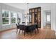 Bright dining room with large windows, round table, and modern wine storage at 1091 Eaglecrest Dr, Winter Garden, FL 34787