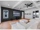 Cozy living room with coffered ceiling, large TV, neutral color palette, and plush white sectional sofa at 1091 Eaglecrest Dr, Winter Garden, FL 34787