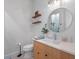 Well decorated powder room with floating shelves, decor, and a modern wood vanity at 1091 Eaglecrest Dr, Winter Garden, FL 34787