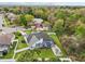 Aerial view of home with fenced backyard, screened pool, patio with chairs, and lush landscaping at 1232 Scandia Ter, Oviedo, FL 32765