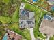 Aerial view of home with solar panels, screened pool, patio with chairs, and landscaped yard at 1232 Scandia Ter, Oviedo, FL 32765