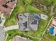 Aerial view of home with solar panels, screened pool, patio with chairs, and fenced-in yard at 1232 Scandia Ter, Oviedo, FL 32765