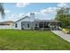 Lush green backyard with a screened-in patio and ample space for outdoor activities at 1232 Scandia Ter, Oviedo, FL 32765