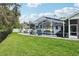 Beautifully landscaped backyard with a screened-in pool and relaxing lounge areas at 1232 Scandia Ter, Oviedo, FL 32765