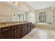 Spacious bathroom featuring double vanities, large mirror, and separate tub and shower at 1232 Scandia Ter, Oviedo, FL 32765