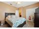 Bedroom featuring a dark leather headboard and tropical themed bedding at 1232 Scandia Ter, Oviedo, FL 32765