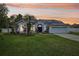 Charming home with a well-maintained lawn, blue accents, arched windows, and efficient solar panels at 1232 Scandia Ter, Oviedo, FL 32765