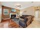 Comfortable living room with hardwood floors, a cozy fireplace, and a mounted television at 1232 Scandia Ter, Oviedo, FL 32765
