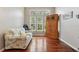 Bright living room with hardwood floors, a large window, and a decorative cabinet at 1232 Scandia Ter, Oviedo, FL 32765