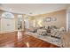 Spacious living area with hardwood floors, beach-themed furniture, and abundant natural light at 1232 Scandia Ter, Oviedo, FL 32765