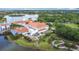 Community aerial view featuring buildings with distinctive architecture, water features, and green spaces at 124 Meridian Ave, Kissimmee, FL 34759
