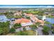 Stunning aerial view showcases a community with vibrant buildings, lush landscaping, and serene lakes at 124 Meridian Ave, Kissimmee, FL 34759