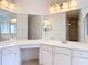Bathroom featuring double mirrors, vanity with cabinets, and shower at 124 Meridian Ave, Kissimmee, FL 34759