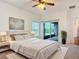 Bedroom featuring a plush bed, soft carpet, ceiling fan, and sliding door to the outside at 124 Meridian Ave, Kissimmee, FL 34759