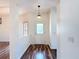 Bright foyer with unique wood flooring, a glass-paneled front door, and modern lighting at 124 Meridian Ave, Kissimmee, FL 34759