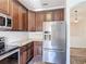 Modern kitchen with granite countertops, stainless steel appliances, and dark wood cabinetry at 124 Meridian Ave, Kissimmee, FL 34759